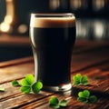 Glass of dark stout sits on wooden table, with sprinkling of shamrocks