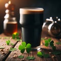 Glass of dark stout sits on wooden table, with sprinkling of shamrocks