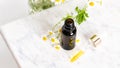 Glass brown bottle of essence or serum and with chamomile flowers Royalty Free Stock Photo