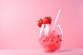 A glass of bubble non classic strawberry margarita garnished with strawberries on pink background. Summer red or pink cocktail