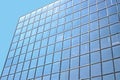 Glass building full of windows against blue sky- photographed from an angle - Great blue tech background with interesting Royalty Free Stock Photo