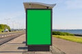 glass bus stop by the sea, with a chroma key advertising space. Blank billboard and outdoor advertising. Mockup poster