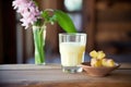 glass of buttermilk on rustic wood with fresh butter cubes