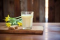 glass of buttermilk on rustic wood with fresh butter cubes