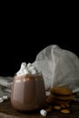 Glass of cacao, marshmallow, oat cookies and almond on cutting board