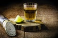 Glass of cachaÃÂ§a, a Brazilian drink distilled from sugar cane, served with lemon, also called pinga, with copyspace Royalty Free Stock Photo