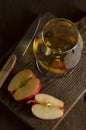 Glass of Calvados Brandy and red apples on wooden table Royalty Free Stock Photo