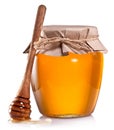 Glass can full of honey and wooden dripper on a white. Royalty Free Stock Photo