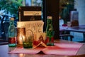 Still life with two green glass bottles in European restaurant interior.