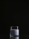 Glass candlestick with a candle isolated on a black background