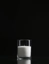 Glass candlestick with a candle isolated on a black background