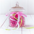 Glass candy jar filled with pink gummy candies