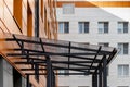 Glass canopy to protect from precipitation at the entrance to a modern office building