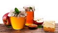 Glass cans full of honey, apples and honeycombs. Clipping paths. Royalty Free Stock Photo