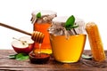 Glass cans full of honey, apples and honeycombs wood. File contains clipping paths. Royalty Free Stock Photo
