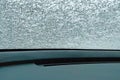 The glass of the car is covered with thin ice. Warming up the car in winter Royalty Free Stock Photo