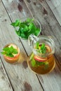 Glass and carafe of green tea with mint and apples Royalty Free Stock Photo