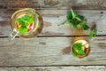 Glass and carafe of green tea with mint and apples Royalty Free Stock Photo