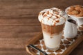 Glass of caramel macchiato on wooden table Royalty Free Stock Photo