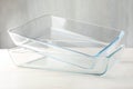 Glass casseroles on light wooden table, closeup Royalty Free Stock Photo