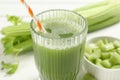 Glass of celery juice and fresh vegetables on white table, closeup Royalty Free Stock Photo