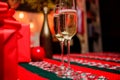 Glass of champagne close up. Champagne couple glasses. Glass filled sparkling wine or champagne near gift boxes. Cheers