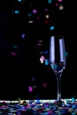 Glass of champagne with with confetti colors on background Royalty Free Stock Photo