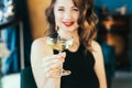 Glass of champagne in the hands of smiling elegant woman in evening dress in the luxury interior. Celebrity, superstar Royalty Free Stock Photo