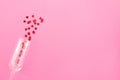 Glass of champagne with red hearts on a pink background. Valentines background, love, date concept with copy space, flatlay Royalty Free Stock Photo