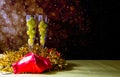 A glass of champagne with several lucky grapes levitating.Two champagne glasses filled with the traditional lucky grapes, with Chr Royalty Free Stock Photo