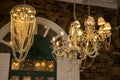 Glass chandelier. Ceiling light source. Lamps shine through a vintage chandelier. Royalty Free Stock Photo