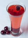 A glass of Cherry Juice close up with cherry fruit and Bubles