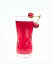 Glass cherry juice and ripe and juicy cherry with green leaves on white background Royalty Free Stock Photo