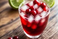 Glass of cherry limeade with cherry slices, lime wedges, and ice cubes. AI generated. Royalty Free Stock Photo