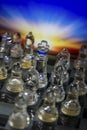 Glass chess and color sunset backdrop macro Royalty Free Stock Photo