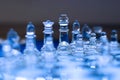 Glass chess game, king with queen, blue tones Royalty Free Stock Photo