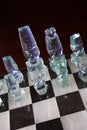 Glass chess pieces on board Royalty Free Stock Photo