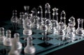 Glass chess pieces are defending the king on board in dark Royalty Free Stock Photo