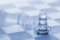 Glass chess. A victory of a pawn over a king Royalty Free Stock Photo