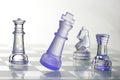Glass chessmen in blue light Royalty Free Stock Photo