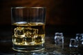 Glass chilled whiskey with ice cubes on wooden background in cellar