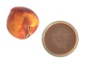 Glass of chocolate milk with a nectarine.