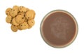 Glass of chocolate milk with small cookies