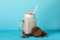 Glass of chocolate milkshake, cookies and almond on blue background Royalty Free Stock Photo