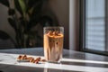 Glass of Chocolate-Peanut Butter Swirl smoothie for breakfast on sunny morning in the kitchen