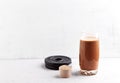 Glass of Chocolate Protein Shake with milk and banana, Whey protein in scoop and black plates in background. Sport nutrition. Royalty Free Stock Photo