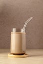 Glass of chocolate shake drink with protein powder scoop and glass straw. Royalty Free Stock Photo