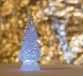 Glass Christmas toy, herringbone on golden blurred background