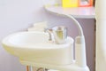Glass chromium on Sink medical equipment dentist Close up, ceramic spittoon and water filler in Clinic Royalty Free Stock Photo