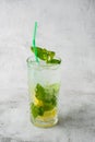 Glass with classic mojito cocktail with lemon and mint, cold refreshing drink or beverage with ice on bright marble background. Royalty Free Stock Photo